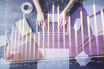 Multi exposure of woman hands working on computer and forex chart hologram drawing. Top View. Financial analysis concept.