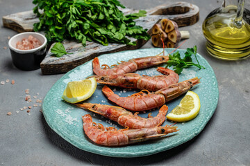 Shrimps, prawns. Seafood Red Argentine shrimps with ice on a light background, Wild shrimps, ocean jumbo shrimps. Long banner format. top view