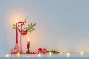 pink christmas decor with burning candles in white interior - Powered by Adobe