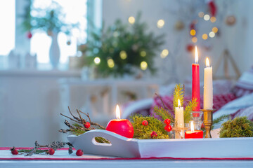 christmas home decorations with candles in red and white colors