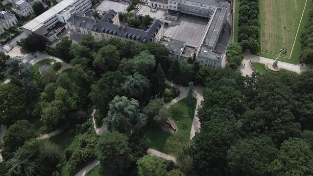 Drone flying over Thabor Park and Anne de Bretagne College, Rennes in France. Aerial top-down forward