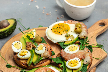 Toast with wholemeal bread, soft fried egg, spinach, avocado, shrimps on wtite background, Ketogenic breakfast. superfood concept. Healthy, clean eating. Top view