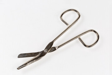 Stainless steel trauma shears on a light surface