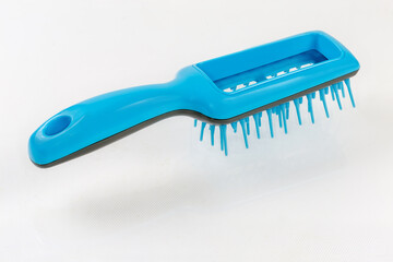 Hairbrush with plastic bristles on a light surface