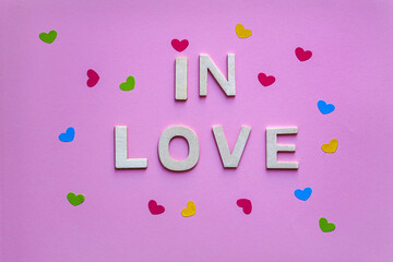 in love word with wooden letters on the pink background, valentine's day