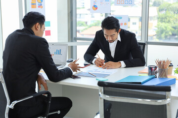 Asian business people meeting and talking in the room, businesswoman present in font of the board with discussion and participation
