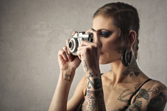young woman takes a picture with a vintage camera