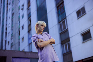 Portrait of a blonde teenage boy in the urban exterior.