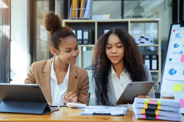 Asian women business people discussing on performance revenue in meeting. businessman working with...