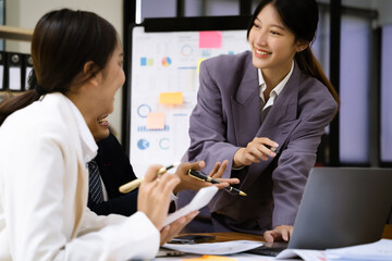Group of Young Asian business team creative businesspeople coworker in office. Meeting Presentation for analysis graph company financial.