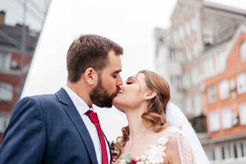 portrait of young bride and groom enjoying romantic moments outside