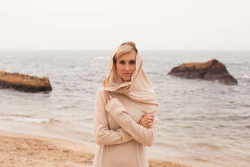 hipster woman walking on sandy beach near sea, closeup