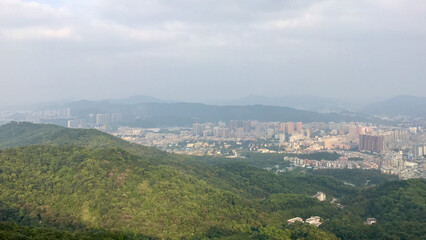 Guangzhou, China, November 2016 - A view of a city with a mountain in the background