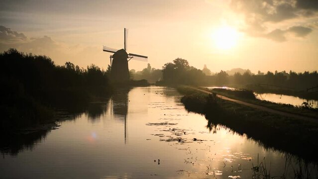 Calm and foggy golden sunrise morning on the Hazerswouder-Dorp windmill,  Rietveldse, Netherlands.