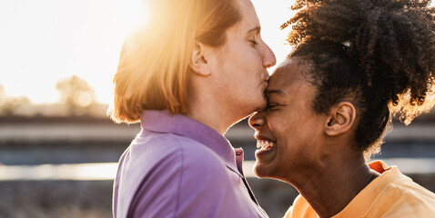 Female gay couple having tender moments during sunset outdoor - Lgbt and love relationship concept