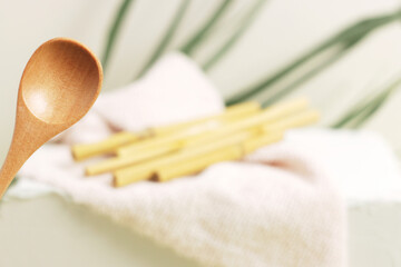 Eco bamboo spoon on green background. Concept, natural material organic cutlery, zero waste,...
