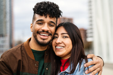Happy young Hispanic Latin couple having fun dating outdoor
