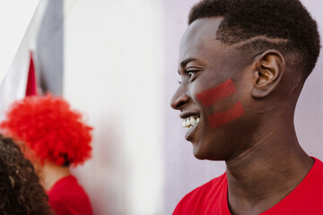 African football fan having fun supporting his favorite team - Sport entertainment concept