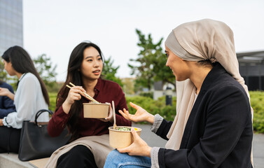 Multiracial business women taking a break for eating a meal outside the office