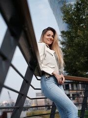 Woman is posing downtown on street.