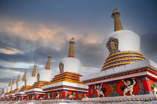Chorten stupas in Ta'er temple, Kumbum monastery with Tibetan snow lions against the sky