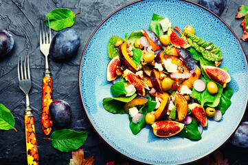 Vitamin salad with fruit, olives and herbs