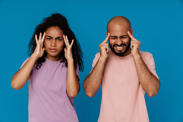 Black man and woman with headache rubbing their temples