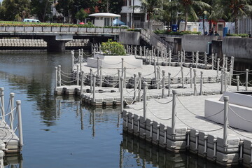 Water canal with small piers in the Kota Tua (Old Town) area of Jakarta, Indonesia. Historical...