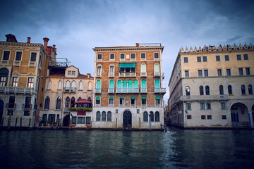 Fototapeta na wymiar Traditional venetian houses and architecture style view across the Grand Canal in Venice, Italy. With Fondaco dei Tedeschi on the right