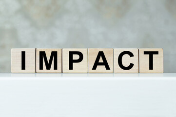IMPACT word written on wooden cubes. IMPACT word written on wooden blocks. Business concept.