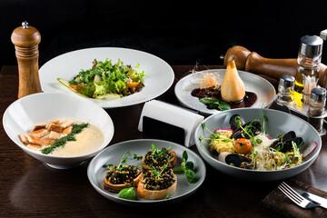 Italian risotto with roasted chicken, snacks on dark wooden table. Italian food table, top view