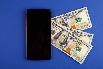 money with phone isolated on blue background