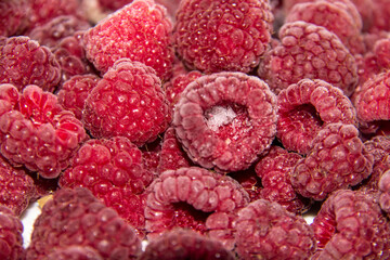 The background from the red frozen raspberries. The natural frozen berry raspberries