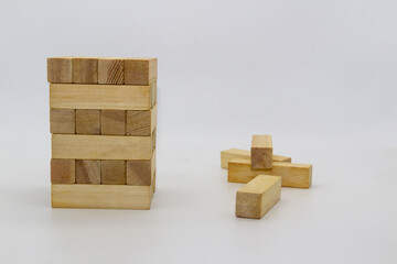 Tower wooden block, builds tower from wooden blocks against white background. The wooden bricks lying around randomly