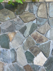 Gray stone wall background, stones of different sizes and shapes