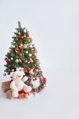 Christmas tree background. Red toys on Christmas tree and gifts. Happy New Year!