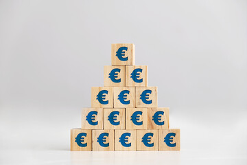 Euro signs on wooden block pyramid