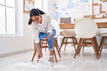 Young beautiful hispanic woman business worker using touchpad reading document at office