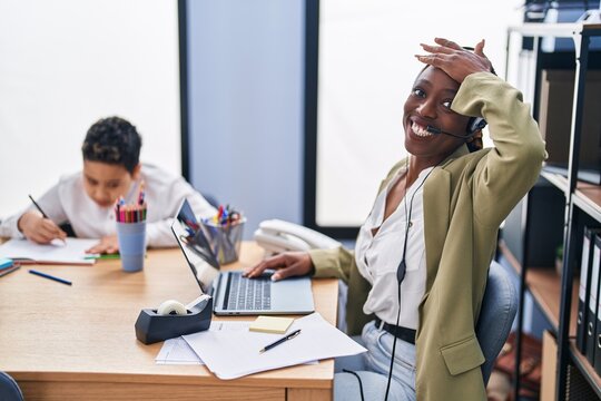 Young Mother Wearing Call Center Agent Headset Stressed And Frustrated With Hand On Head, Surprised And Angry Face