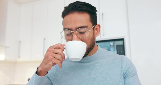 Asian man, coffee and happiness while drinking hot beverage, drink or tea standing in kitchen smelling aroma to relax, smile and for energy. Happy male working from home feeling calm and free