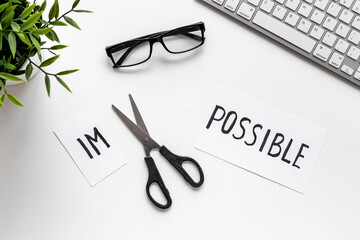 It is possible concept. Word Impossible becomes Possible with scissors