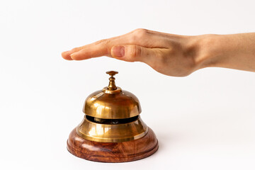 Fototapeta na wymiar Hand on metal golden service bell. Attention concept