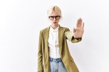 Beautiful caucasian business woman standing over isolated background doing stop sing with palm of the hand. warning expression with negative and serious gesture on the face.