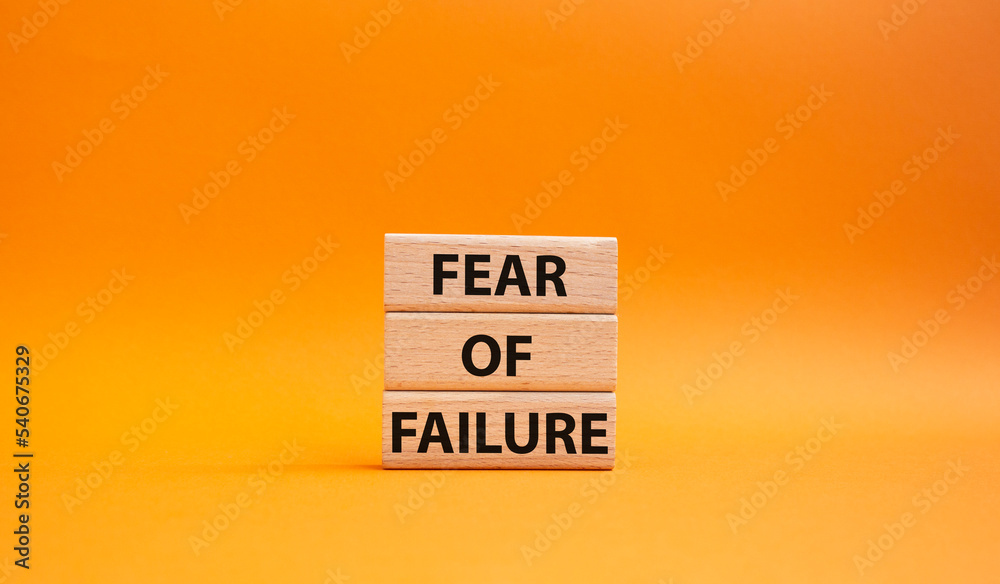 Fototapete fear of failure symbol. concept words fear of failure on wooden blocks. beautiful orange background.