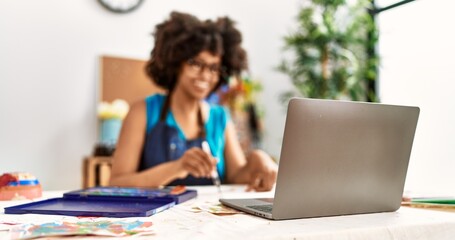 Young african american woman smiling confident having online draw class at art studio