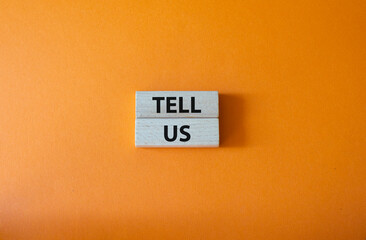 Tell us symbol. Concept words Tell us on wooden blocks. Beautiful orange background. Business and Tell us concept. Copy space.