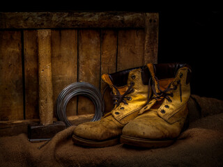 Men's old leather work boots with objects. Still life.