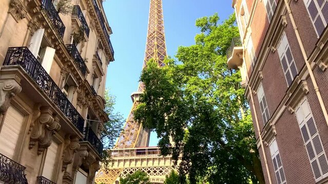 Looking Up On Eiffel Tower From Parisian Street Between The Apartments In Paris, France. - dolly forward