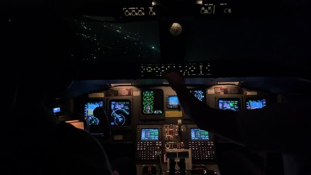 Awesome night view of a jet cockpit during a left turn toward Palma de Mallorca Airport. 1000 metres high. 4K.