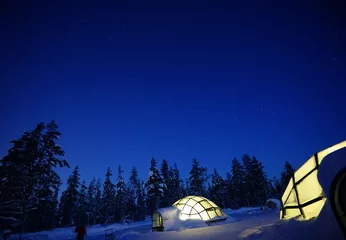 Fotobehang A glass igloo in the snow at night. A glass house for viewing the Northern Lights. Finland © twabian